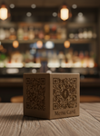 Cardboard box with QR code on a wooden table in a bar setting